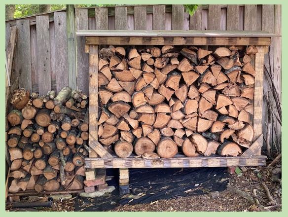 The photo depicts a firewood rack full of firewood.